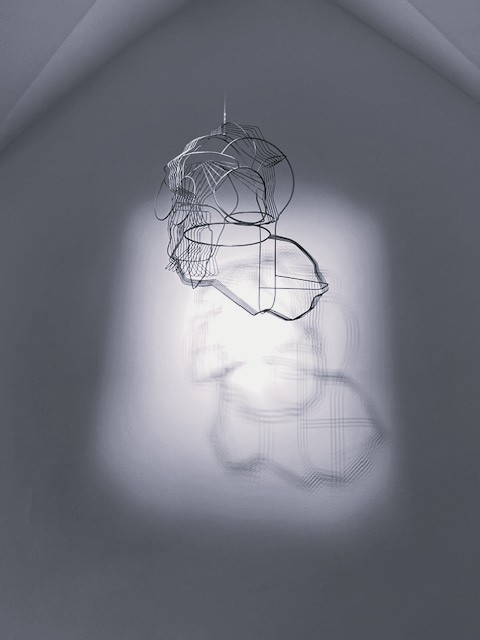 Drahtskulptur von Constantin Luser mit komplexem Schattenspiel an der Wand. Foto: Christa Linossi.